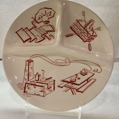 a white plate with red drawings on it