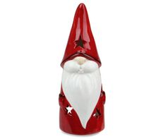 a red and white santa claus figurine with stars on it's face