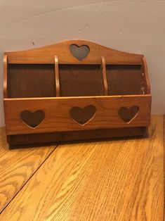 a wooden box with hearts cut out of it