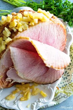 sliced ham on a plate with pineapples and parsley