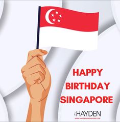 a hand holding a flag with the words happy birthday singapore