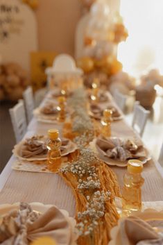 a long table is set with plates and napkins