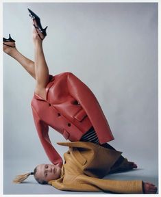 a woman is laying on the ground with her legs spread out and heels in hand