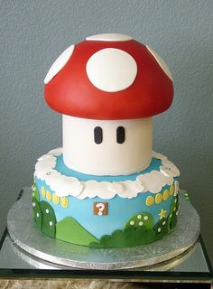 there is a cake that looks like a mushroom house on top of the cake stand