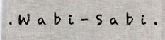 the word wabi - sabi written in black ink on a gray t - shirt