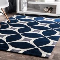 a blue and white rug in a living room