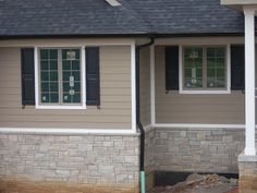 a house that is under construction with some windows on the front and side of it