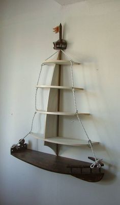 a wooden shelf with a metal chain hanging from it