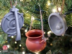 three clay ornaments hanging from a christmas tree