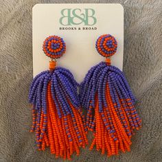 the orange and purple beaded earrings are on display