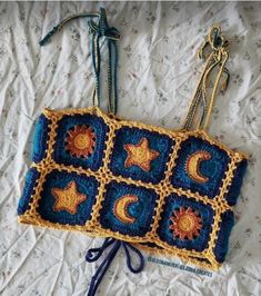 a crocheted purse sitting on top of a bed