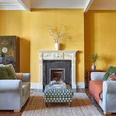 a living room with yellow walls and furniture