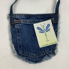 a blue jean pocket with a dragonfly sticker on it