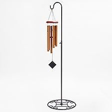 a wind chime is hanging from a pole