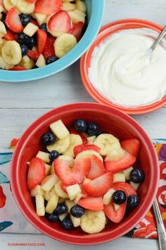 two bowls filled with fruit and yogurt on top of a table