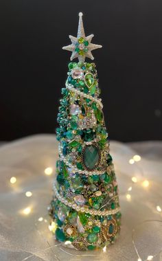 a small christmas tree made out of beads