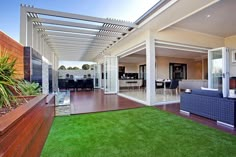 an outdoor living area with grass and wooden decking