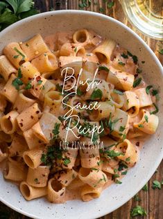 a white bowl filled with pasta and garnished with parsley