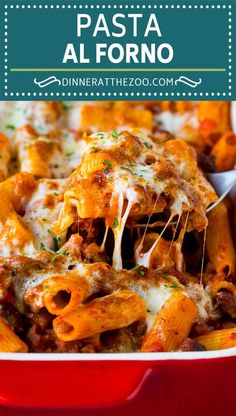 a red casserole dish filled with pasta and meat, topped with parmesan cheese