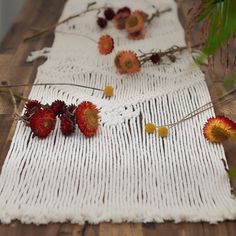 strawberries and dried flowers on a white table runner