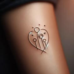 a small tattoo on the side of a woman's stomach with two hearts and stars