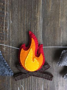 a felt fire is hanging on a clothes line