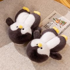 two stuffed birds sitting on top of a table