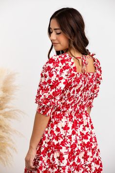 You’ve just secured your new favorite dress! The Elaine Dress is the epitome of beauty, featuring a bold, red floral pattern that makes a statement in any setting. The flattering square neckline and puff sleeves elevate your look, while the form-fitting bodice and tiered midi skirt create an elegant silhouette you’ll love. STYLE INFO & CARE The smocked bodice for a flexible, comfortable fit Tiered Skirt Skirt lined 100% polyester Tie detail in the back Maternity friendly style Machine Washable i Red Floral Print Puff Sleeve Dress, Floral Square Neck Dress With Smocked Bodice, Red Fitted Puff Sleeve Dress For Spring, Red Smocked Bodice Dress With Square Neck, Red Square Neck Dress For Brunch, Square Neck Floral Dress, Tiered Midi Skirt, Tier Skirt, Square Necklines