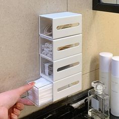 a person's hand is reaching for the drawer