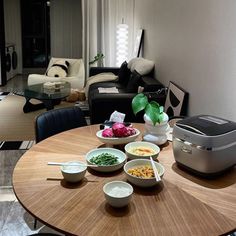 a dining room table with bowls of food on it