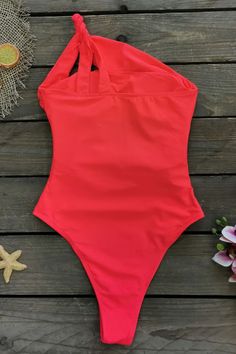 Product Name: Red One Shoulder Cross Monokini Swimsuit Fabric composition: 88% nylon 12% spandex. Weight: 400g/0.9lb. Size: S, M, L Color: Red Package Contains: One Piece Swimsuit x1 Bottom Style: Mid Waist One Piece Style: One-piece swimsuit with removable chest pad. Garment Care: Washing your swimsuit by hand in cold water is a gentle and effective way to keep it looking its best. Red Stretch Nylon Bodysuit, Solid Color Stretch Backless Tankini, Red High Stretch Swimwear For Summer, Red Fitted Nylon Swimwear, Fitted Red Nylon Swimwear, High Stretch Backless Swimwear, Red One-piece Nylon Swimwear, Red Stretch One-piece Swimsuit, Red Nylon Swimwear For Beach Season