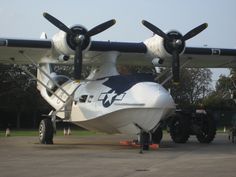 an airplane is parked on the tarmac with two large tires attached to it's wings