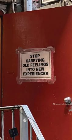 a sign on the side of a red wall that says stop carrying objects in new experiences