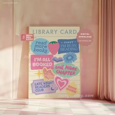 a library card with stickers on it in front of a pink wall and checkered floor