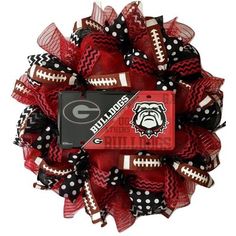 the university of georgia football wreath is decorated with black and red mesh