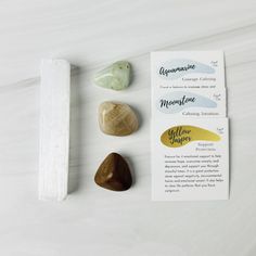 some rocks and paper on a white table