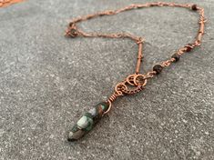 The handmade bohemian chic necklace features a unique stone pendant hung from intricate elements wrapped in high-quality pure copper wire. The organic layered shapes create an elegant ethnic style that's both modern art deco and eclectic boho chic. A one of a kind statement necklace with 100% handmade parts right down to the clasp. ## Shop the Collection This piece is part of the Bromeliad collection, inspired by bromeliads' exotic elegance. Straight bold lines, organic layered wirework, and gem Bohemian Copper Crystal Necklaces With Natural Stones, Bohemian Crystal Necklaces With Natural Stones In Copper, Bohemian Wire Wrapped Copper Wire Necklaces, Bohemian Copper Wire Wrapped Necklaces, Bohemian Wire Wrapped Copper Wire Necklace, Bohemian Copper Electroformed Necklace, Green Bohemian Hand Wrapped Necklace, Bohemian Green Hand Wrapped Necklace, Bohemian Teardrop Pendant Hand Wrapped Jewelry