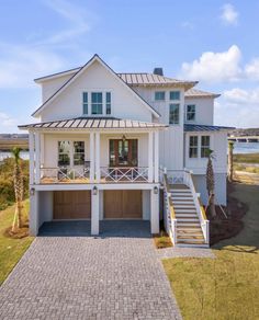 this is an aerial view of the house and its driveway, with stairs leading up to the front door