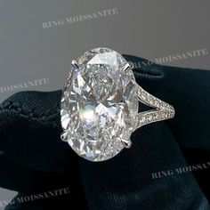 an oval cut diamond ring with pave diamonds on it