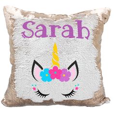 a sequin pillow with an unicorn face and flowers on the front that says, sahara