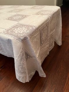 a white tablecloth on top of a wooden floor