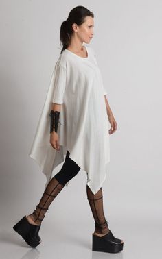 Oversize Long Tunic - METT0105 Be modern in white with this maxi tunic. Because of the loose fit, this top is super easy to wear and perfect for an every day use. It has beautiful asymmetric draping and can easily be paired with a lot of different pants and leggings. Put a pair of heels and a few accessories to make the outfit whole. This asymmetric tunic is made of 100% cotton. NOTE! The color is off white! WHEN YOU PLACE AN ORDER YOU MUST LEAVE A TELEPHONE NUMBER AND CORRECT COORDINATES! WE DO Oversized Bohemian Short Sleeve Blouse, Free Size Short Sleeve Blouse, Bohemian Half Sleeve Relaxed Fit Blouse, Oversized Bohemian Tunic Blouse, Bohemian Oversized Tunic Tops, Oversized Bohemian Tunic Tops, Oversized Cotton Bohemian Blouse, Oversized Top With Asymmetrical Hem For Daywear, Oversized Cotton Blouse With Asymmetrical Hem