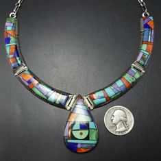 "ALVIN YELLOWHORSE NECKLACE DESCRIPTION: Top-tier Navajo silversmith Alvin Yellowhorse has opened his crayon box of gemstones and created a colorful work of wearable art. Micro inlay of turquoise, sugilite, variscite, lapis, orange spiny oyster shell, jet, and denim lapis set in heavy gauge sterling silver. This extraordinary necklace will be a cherished addition to your collection of the very finest Native American jewelry. MEASUREMENTS: Necklace measures 16\" Pendant measures 1 7/8\" x 1 1/8\" Unique Multicolor Inlay Necklaces, Unique Multicolor Inlay Necklace, Multicolor Inlay Southwestern Necklace, Vintage Multicolor Sterling Silver Jewelry, Vintage Multicolor Inlay Jewelry, Vintage Multicolor Inlaid Jewelry, Multicolor Round Collectible Jewelry, Multicolor Round Necklace For Collectors, Multicolor Round Inlay Necklaces