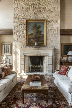 a living room with two couches and a fire place in it's center