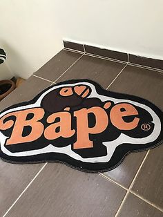 a bath mat with the word bape on it