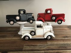 three toy trucks sitting on top of each other