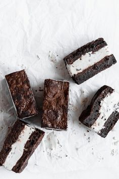 four pieces of chocolate cake with white frosting