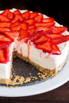 a cheesecake with strawberries is cut into slices