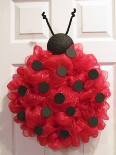 a ladybug wreath hanging on the front door