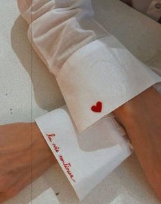 a person's arm with a red heart on it